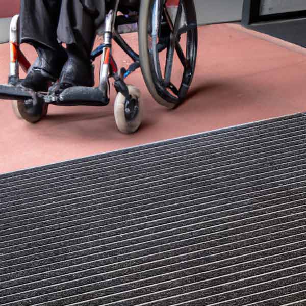 How to Choose the Right Indoor Mat for your Needs. A Step-by-Step Guide 2 Wheelchair approaching entrance mat